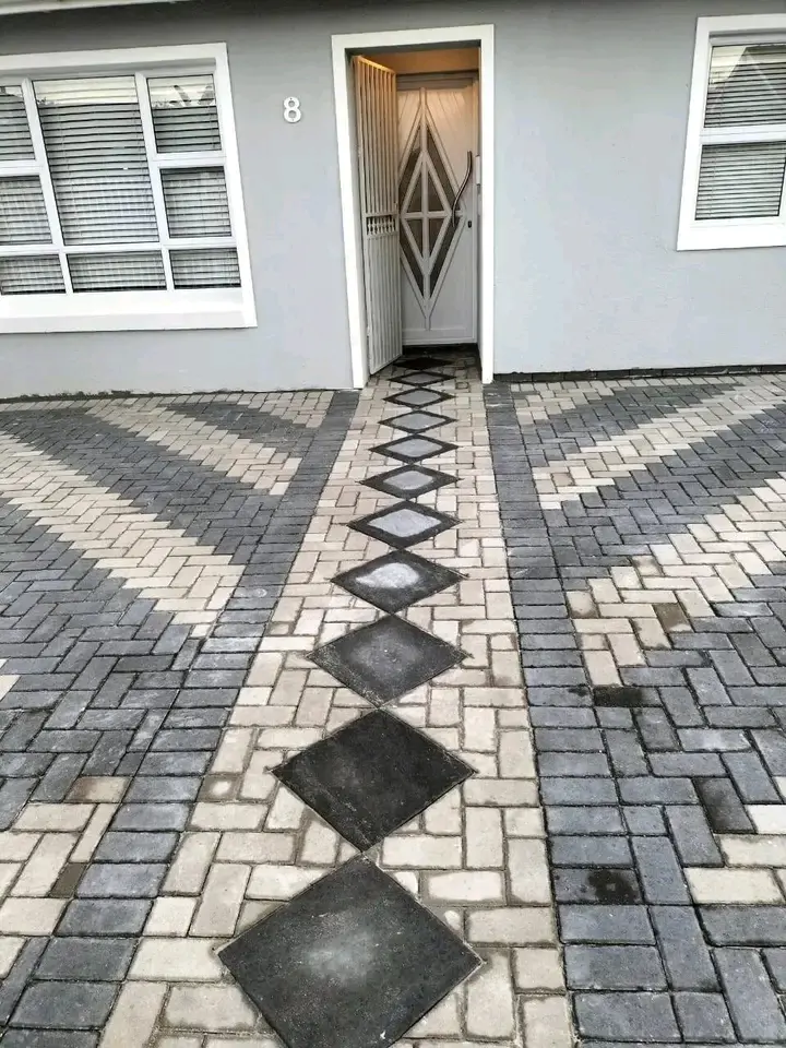 Black and grey paved home entrance with diamond detail